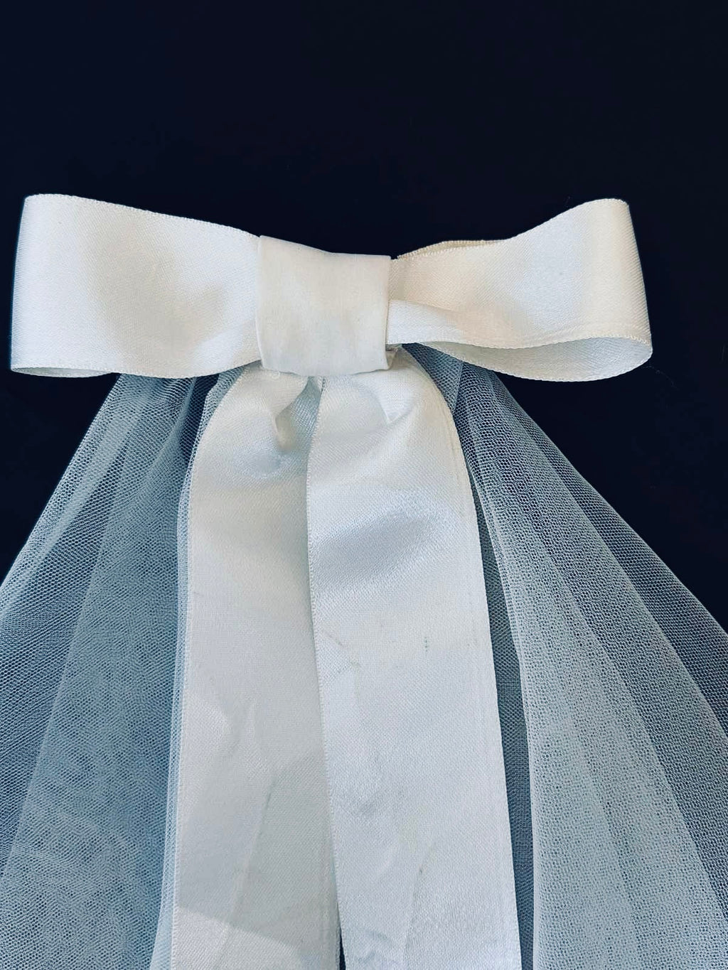White satin bow on bridal veil