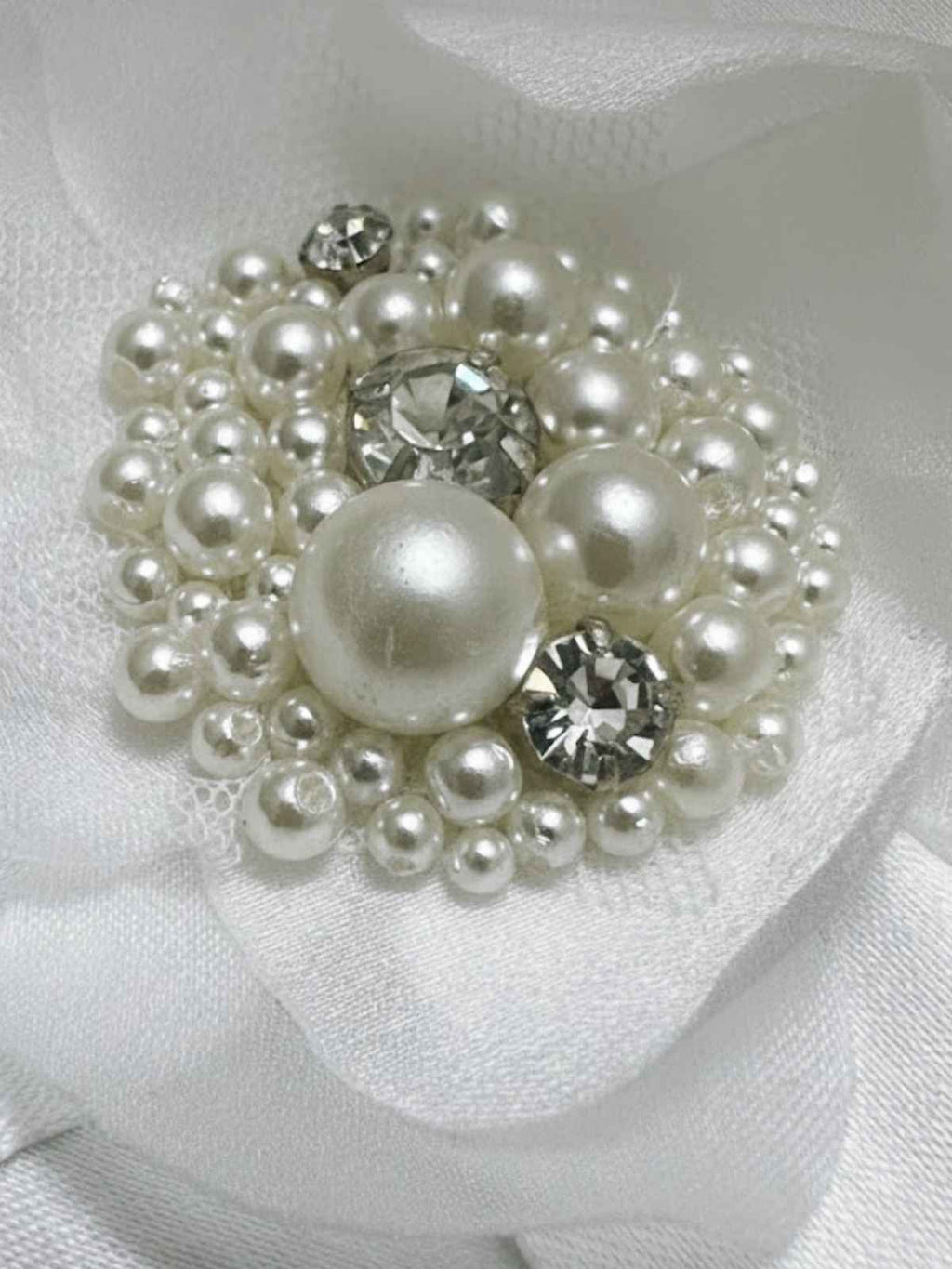 Pearl and crystal brooch on a white fabric handmade flower