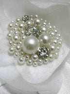 Pearl and crystal brooch on a white fabric handmade flower