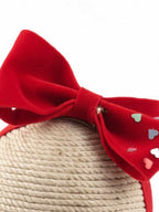Red bow with heart patterns on a dummy