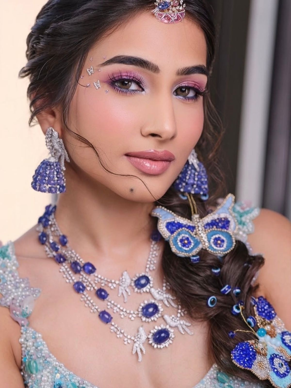 Woman wearing elaborate evil eye inspired hand embroidered butterflies in hair