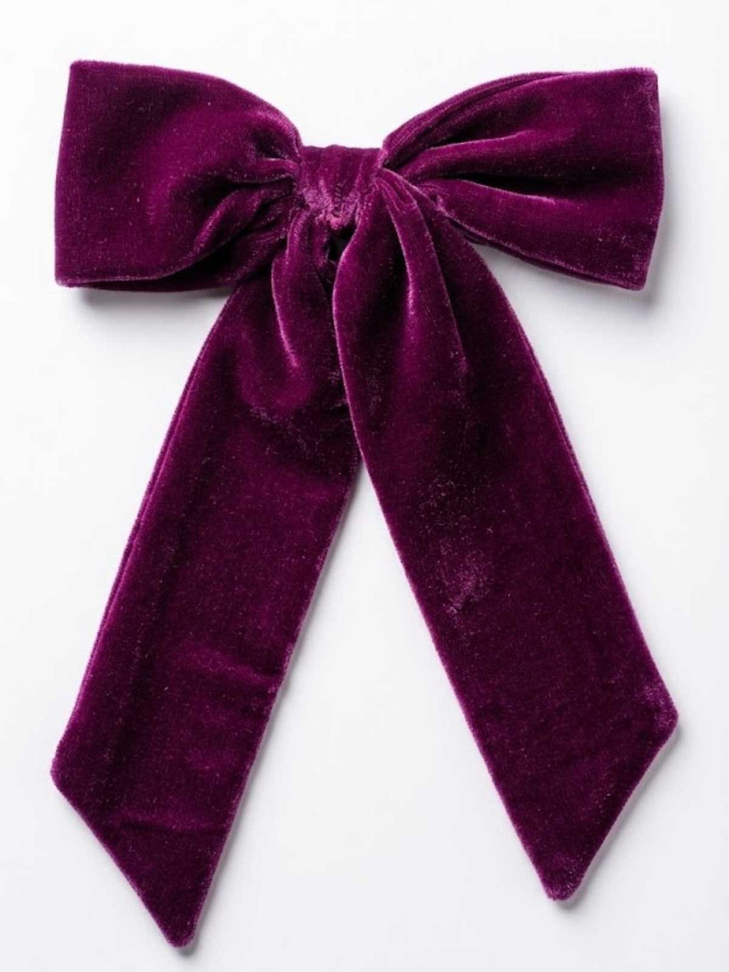 Purple velvet bow on a white background