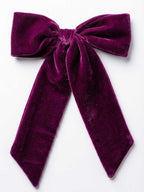 Purple velvet bow on a white background