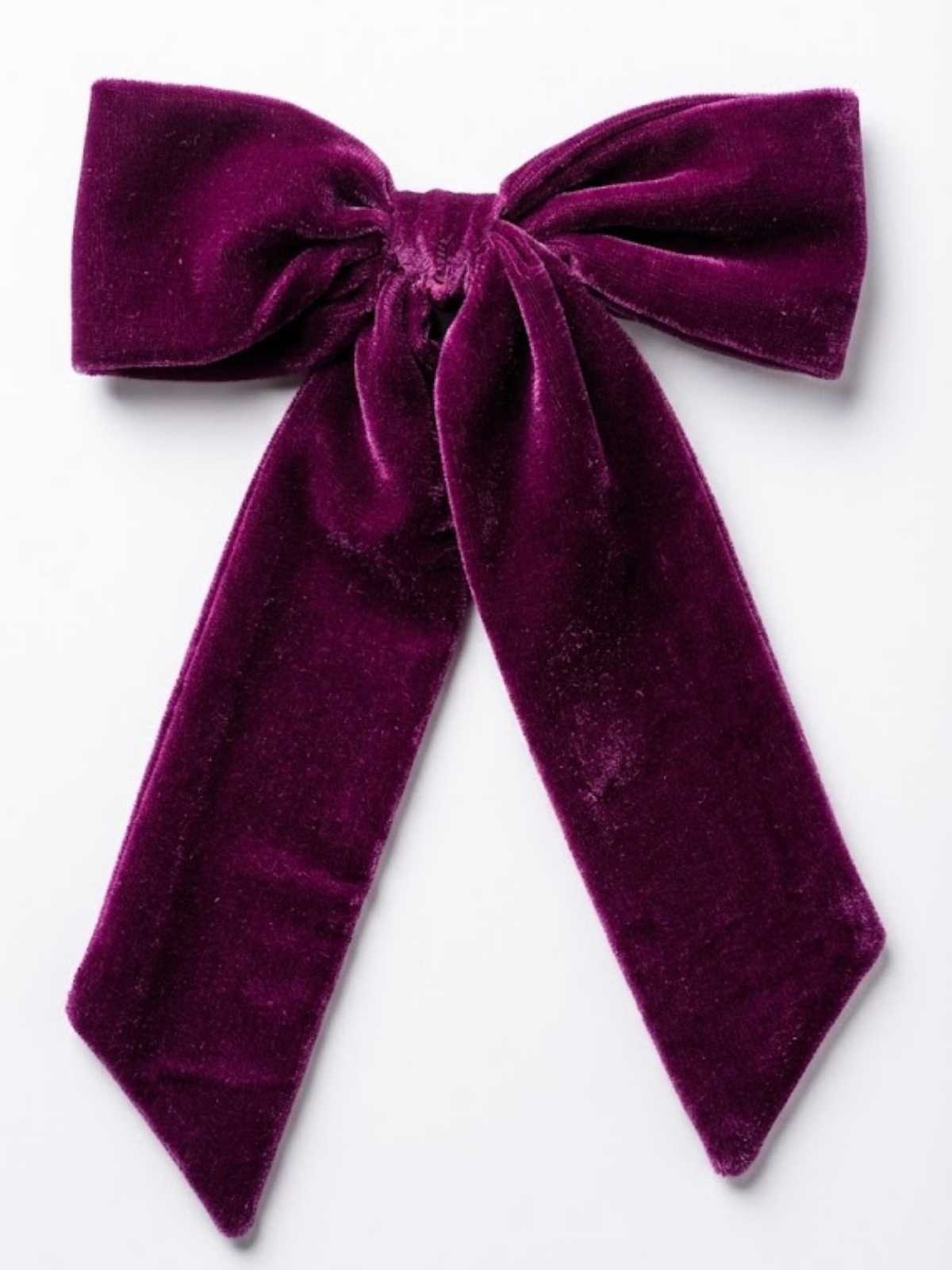 Purple velvet bow on a white background
