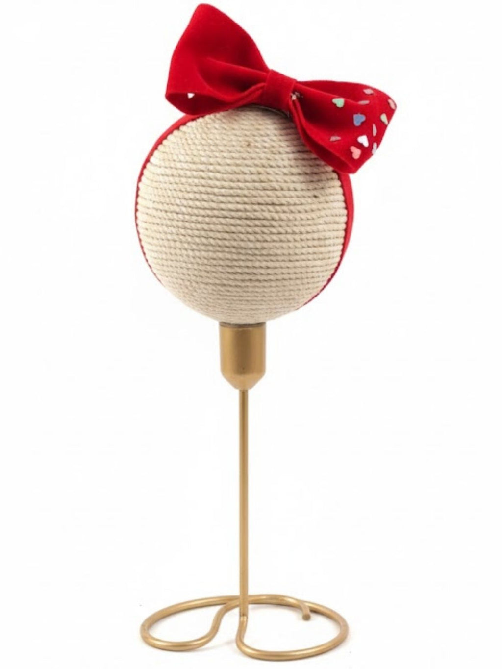 Red big velvet hair bow on baby band with hearts on gold stand on a white background
