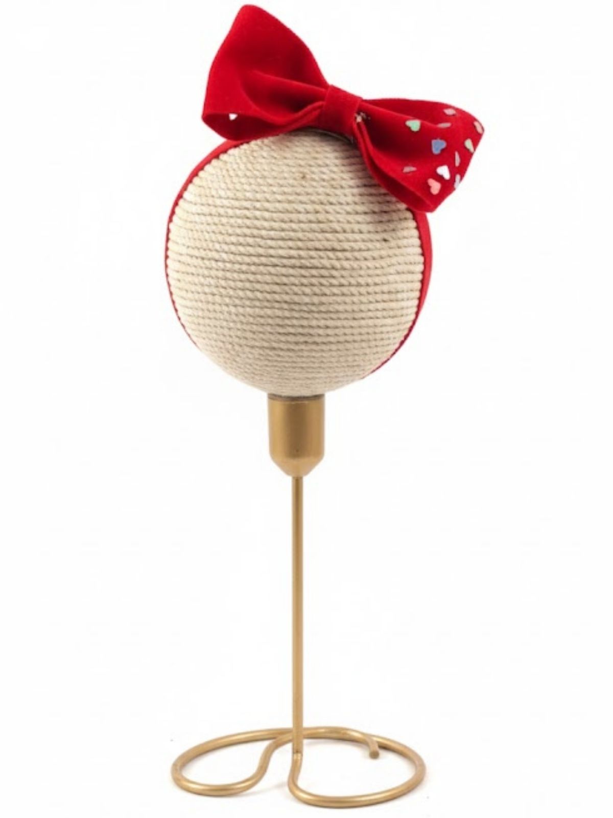 Red big velvet hair bow on baby band with hearts on gold stand on a white background