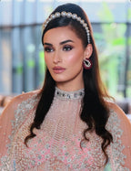 Woman wearing a pearl headband and traditional outfit by suneet verma