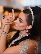 Woman wearing big pearl hairband