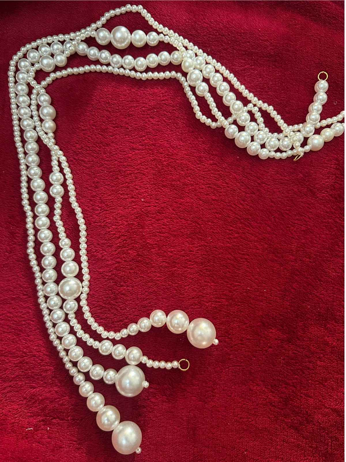 Pearl parandi hair tassels on a red fabric background