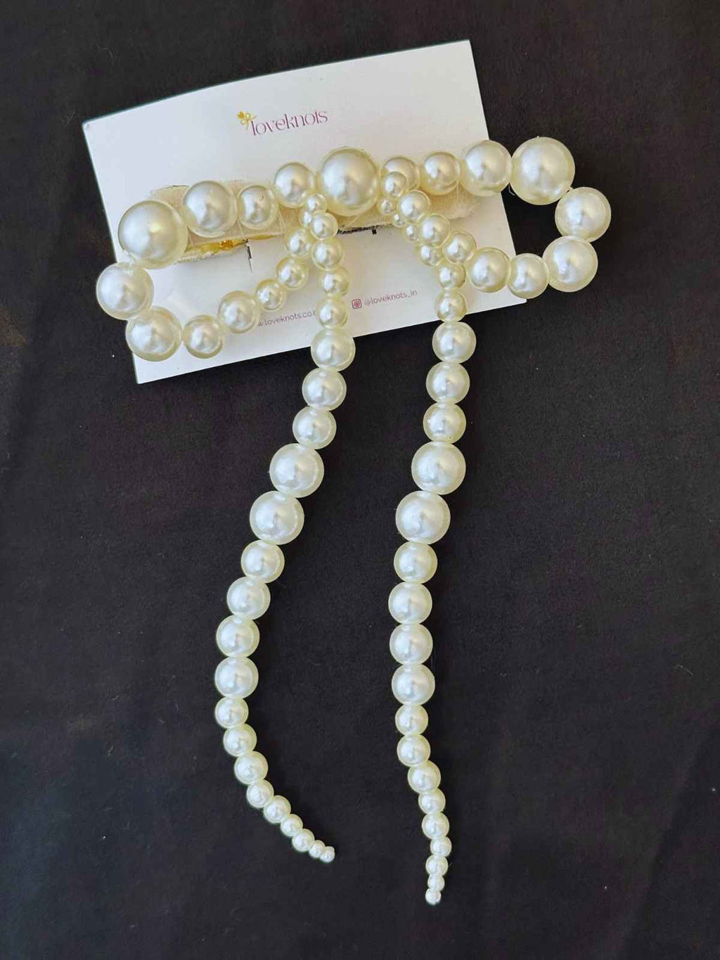 Flatlay of pearl bow