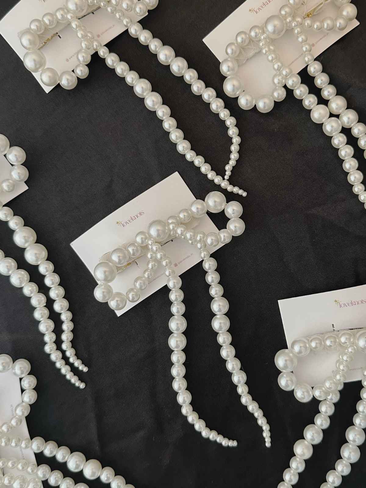 Many pearl bow lying on black background