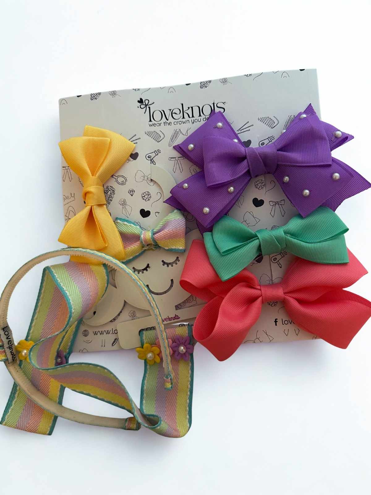 Colorful set of 4 hair bows with a headband and bow holder on a white background