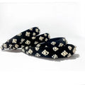black velvet hairbands with pearl embellishments on a white background