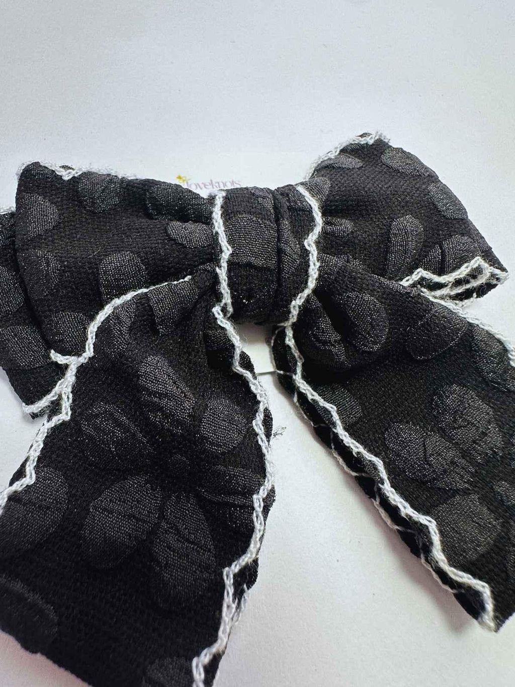 detail of black scalloped cheer bow by loveknots