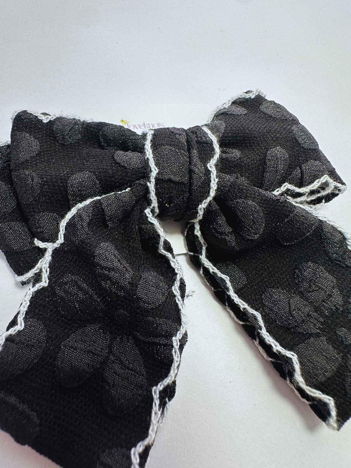 detail of black scalloped cheer bow by loveknots