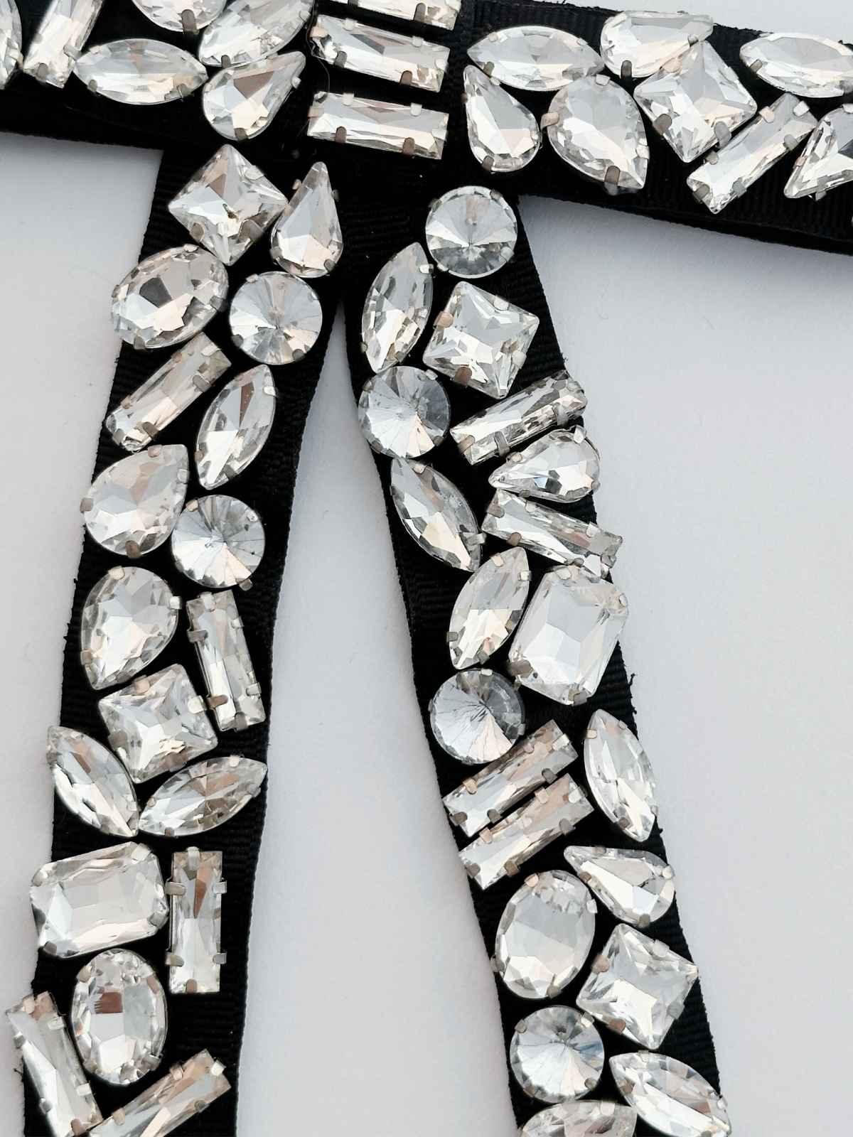 closeup of crystal stones handmade hair bow on a white background