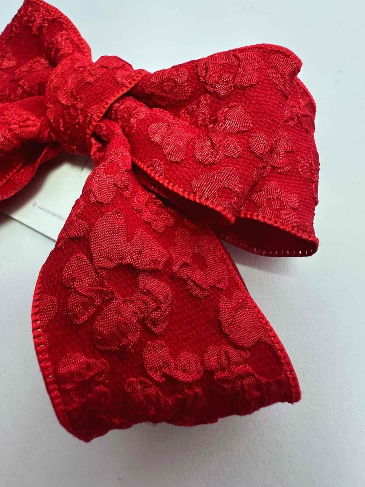 closeup of red cheer bow which is perfect for holidays
