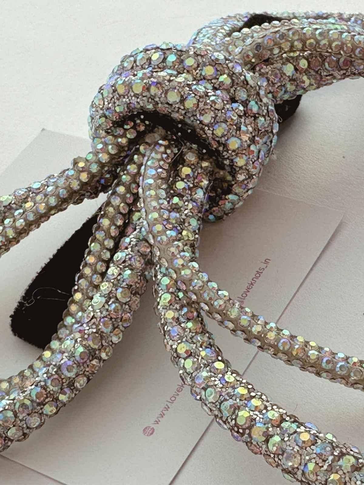 Close-up of a bow with sparkling rhinestone laces on a white background