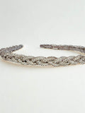 crystal braided hairband lying on white surface