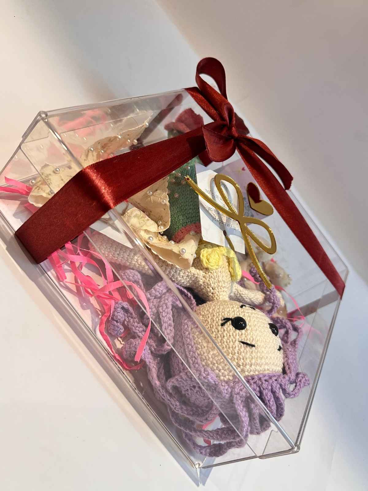 Closeup of crystalux transparent acryllic gift box showing mermaid doll and hair clips
