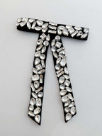 Black bow with silver rhinestones on a white background