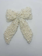 Pearl bow on a light gray background