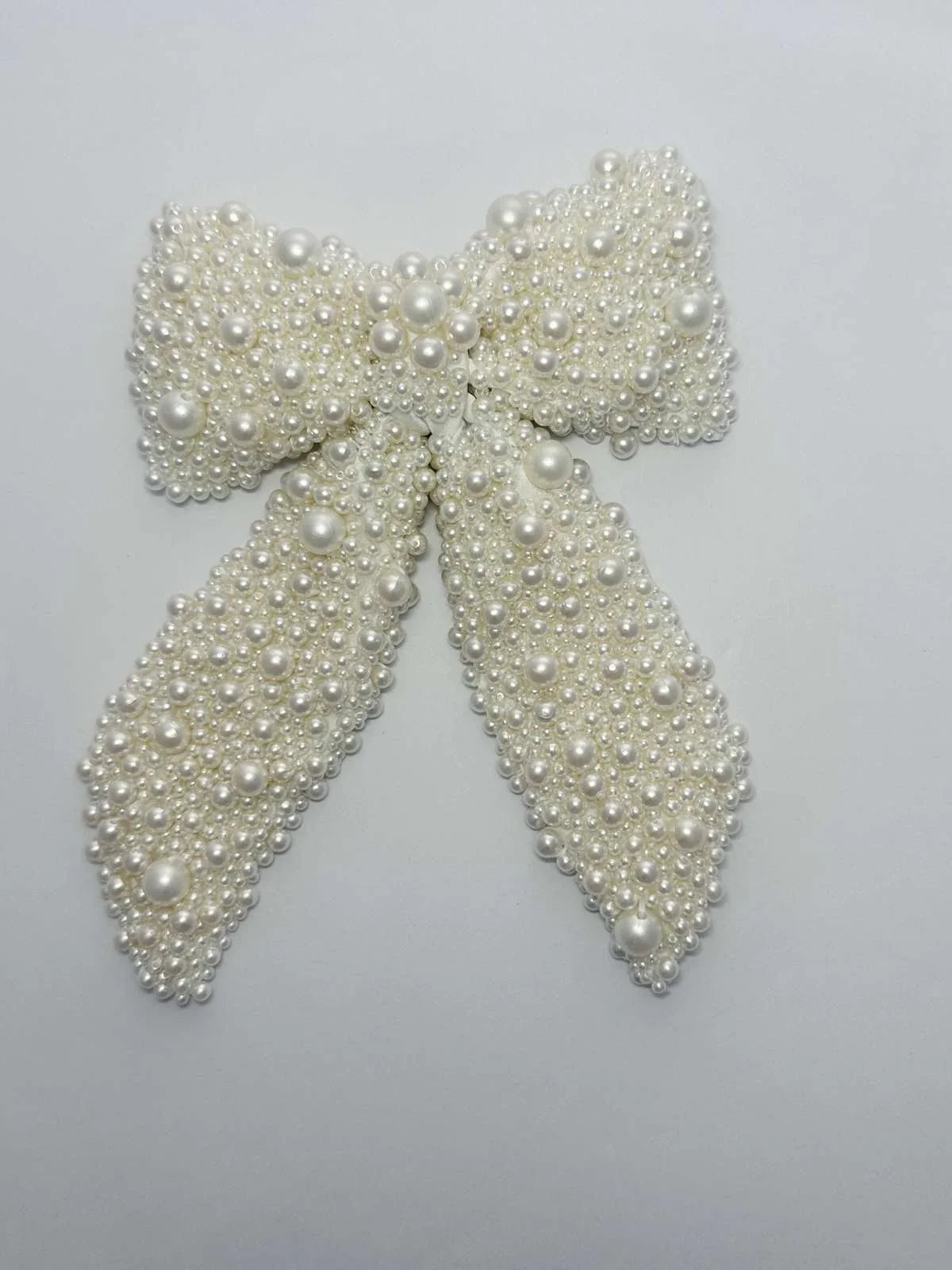 Pearl bow on a light gray background