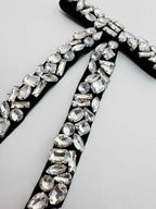 Close-up of a decorative ribbon with rhinestones on a white background