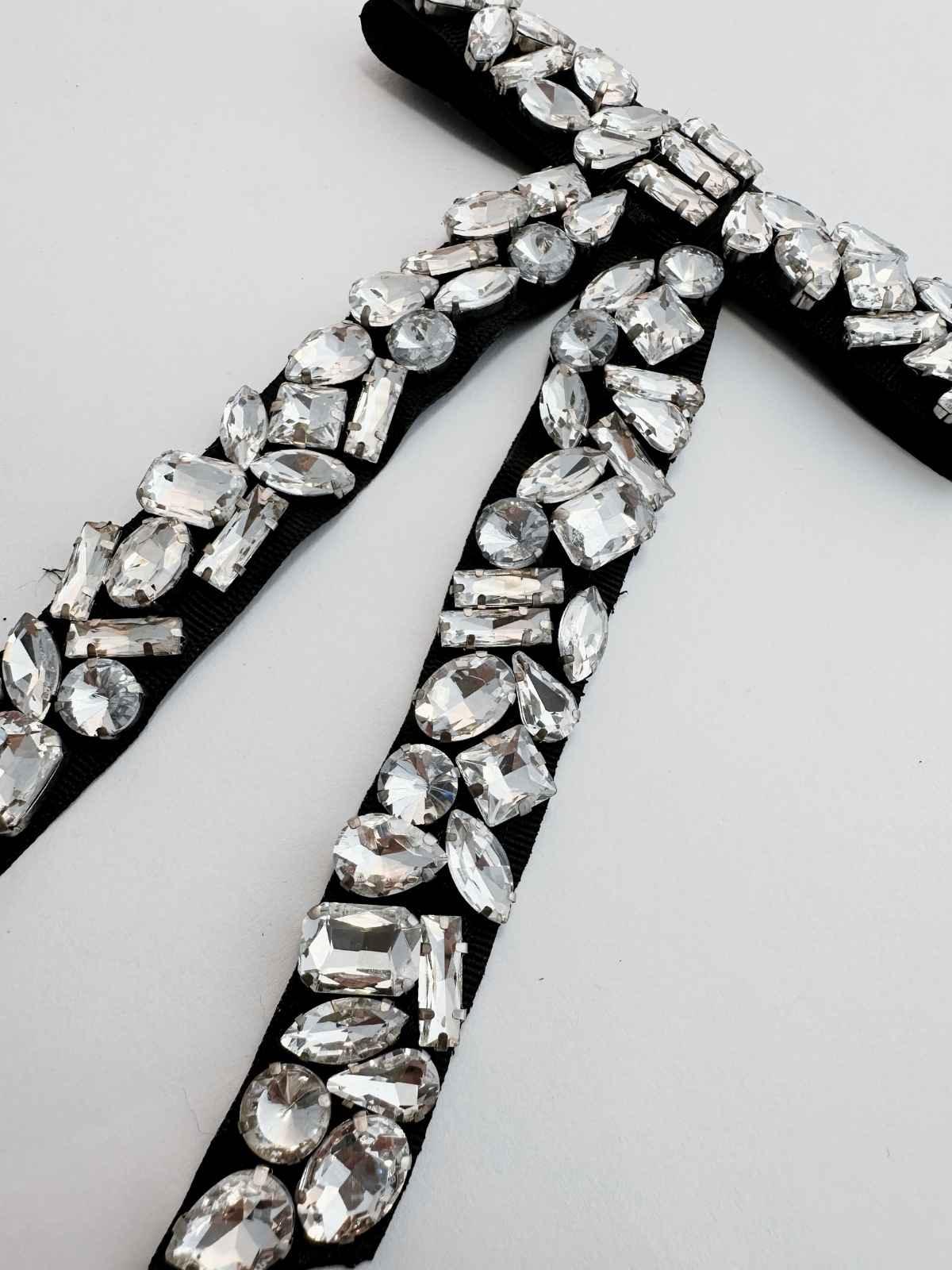 Close-up of a decorative ribbon with rhinestones on a white background