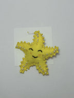 yellow star-shaped hair clip with pearl embellishments on a loveknots white background