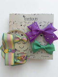 Colorful hair bows with bow holder and hairband on a branded loveknots box