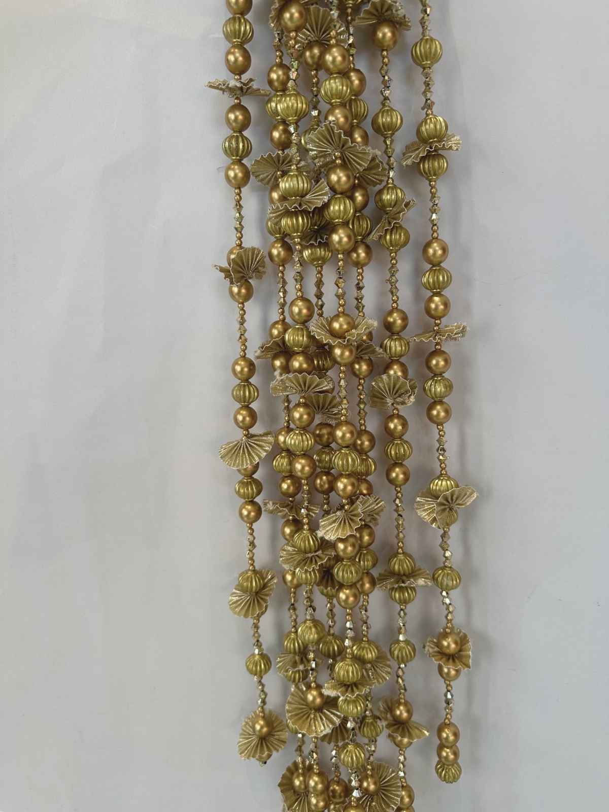 Gold beaded lateen parandi with floral designs on a white background