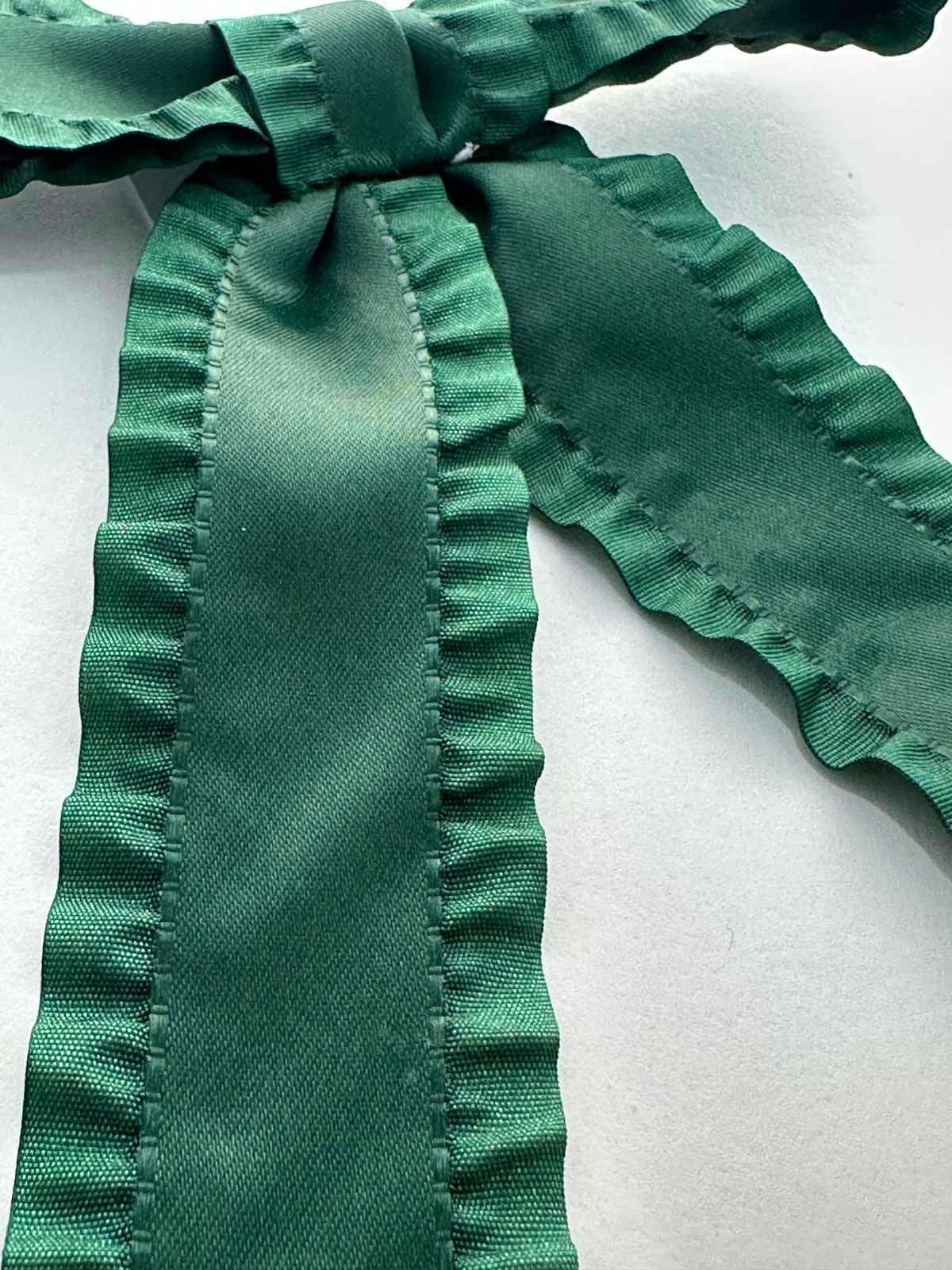 closeup of jade coloured silk fringe bow by loveknots