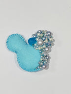 Blue felt Mickey Mouse with bead embellishments on a white background
