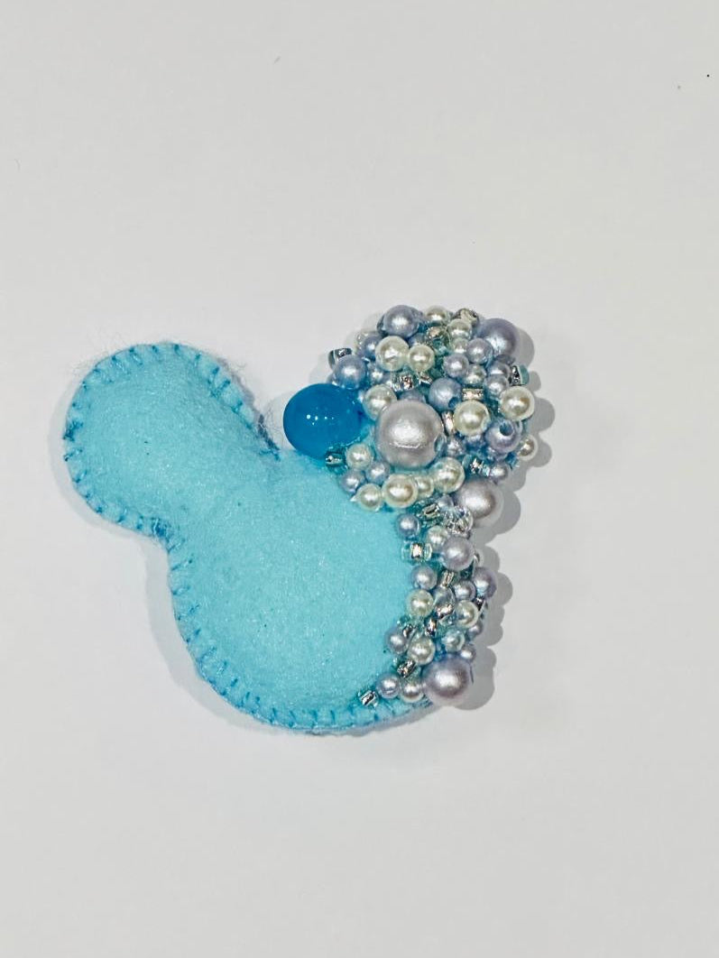 Blue felt Mickey Mouse with bead embellishments on a white background