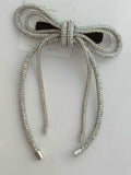 crystal multicolour bow hair accessory on a white background