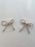Pair of crystal-embellished bow hair clips with metallic accents on white cards