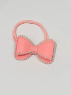Pink hair bow with pearl embellishments on a baby band
