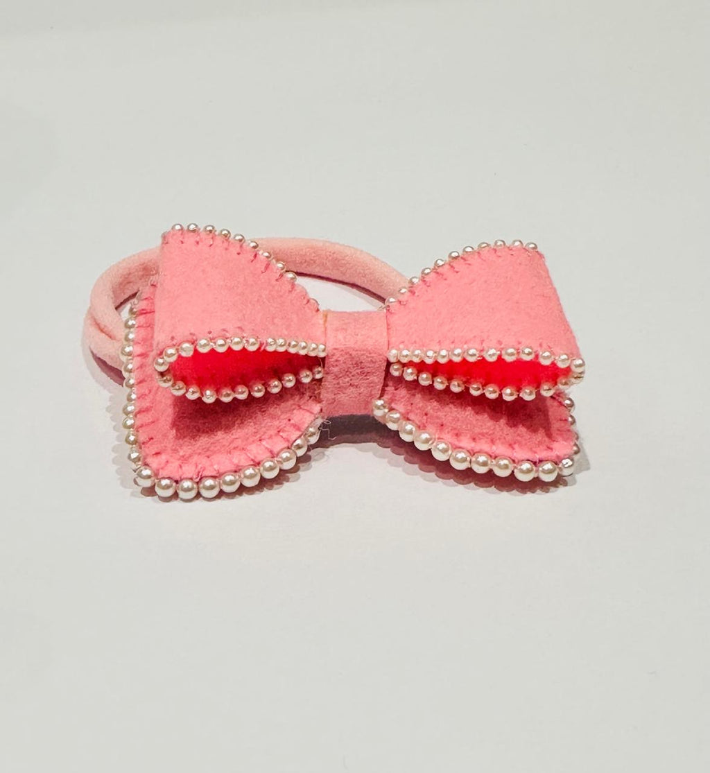 Pink bow hair accessory with pearl details 