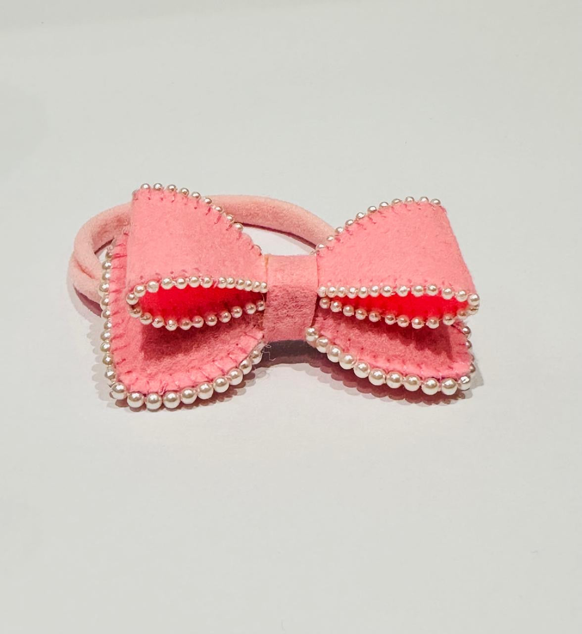 Pink bow hair accessory with pearl details 