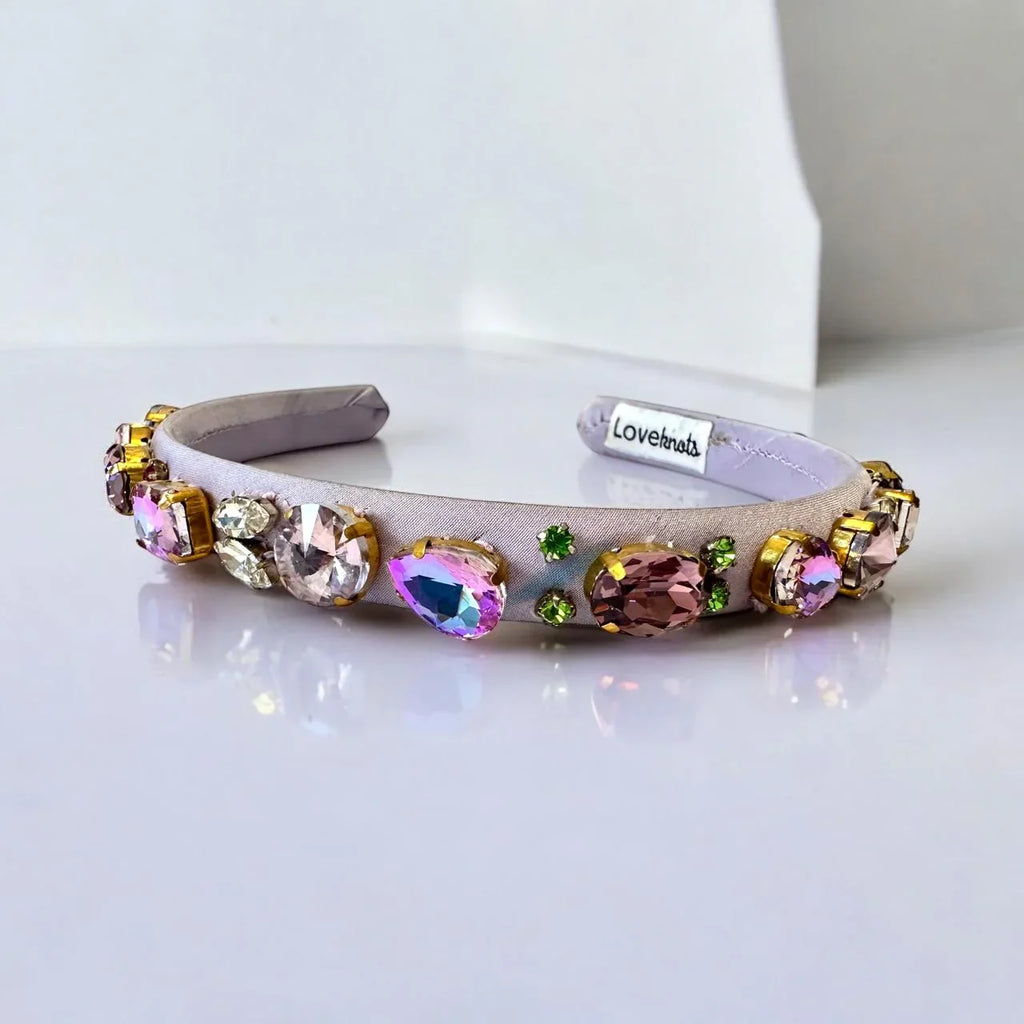 purple headband with colorful crystals on a white background