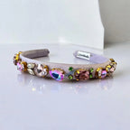 purple headband with colorful crystals on a white background