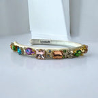 white hairband with colorful gemstones on a white background